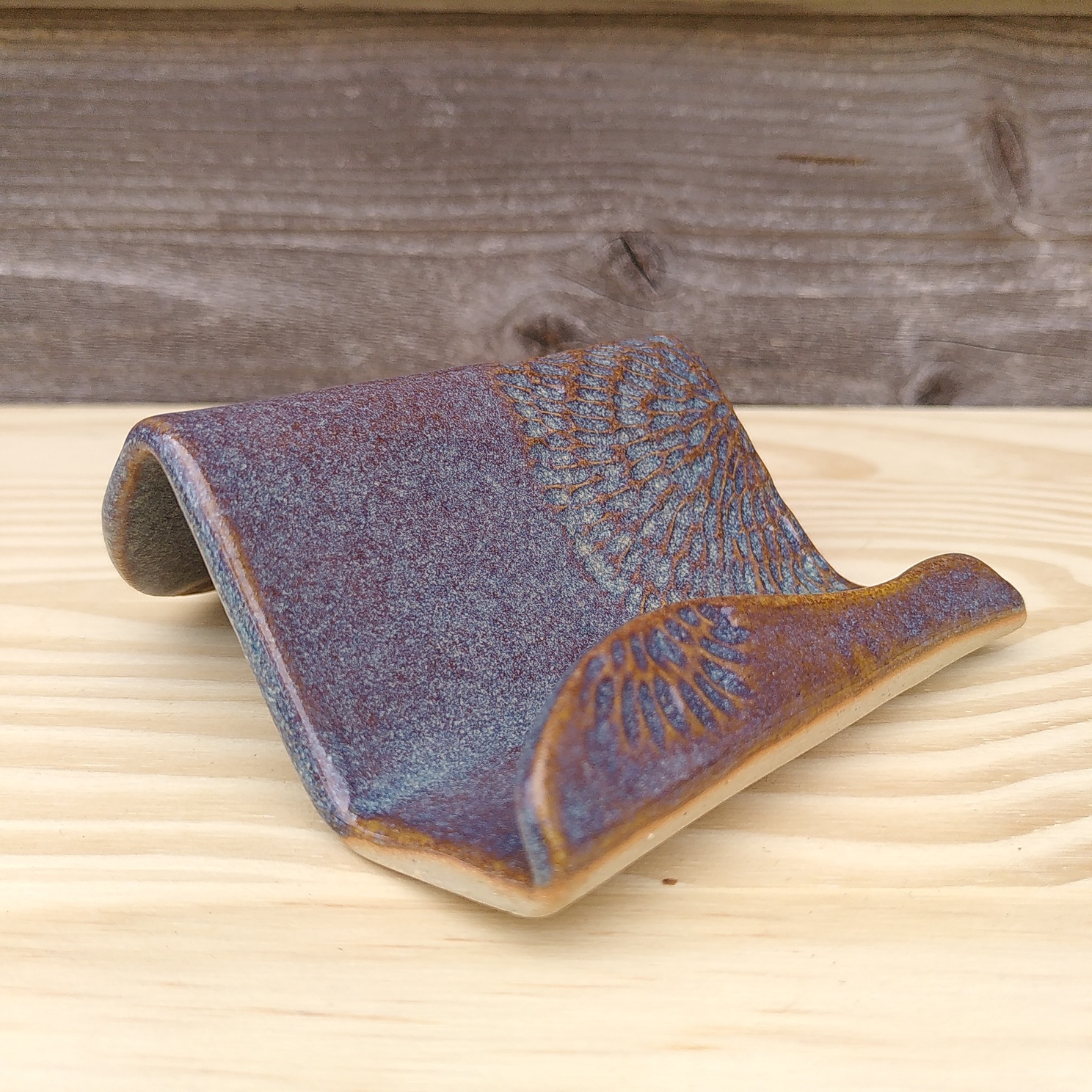 Porte-cartes bleu vague Un porte-cartes en céramique bleu en forme de vague et gravé.